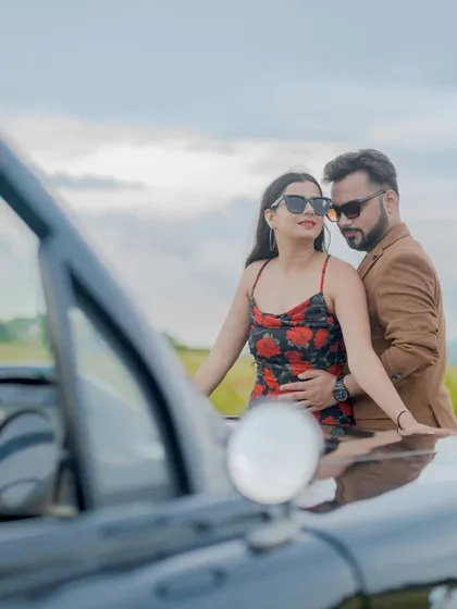 An intimate moment by the vintage car. This photo captures the romance and style of their Goa adventure.