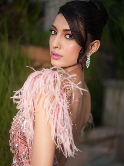 A chic and modern take on a bridal updo. This look is perfect for a cocktail party, with its clean lines and sophisticated silhouette.