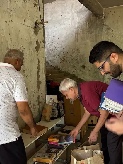 Residents carefully sort through books and other household items during a collection drive. We ensure that usable items like books find new homes or are recycled properly.