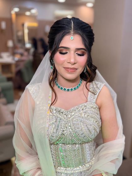 Eyes closed to show the soft, shimmery eyeshadow. The blend is seamless, creating a beautiful and polished look.