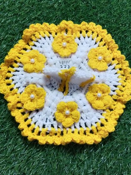 A lovely summer poshak in white and yellow, decorated with six small, hand-crocheted yellow flowers. Each flower is centered with a tiny pearl for a touch of elegance.