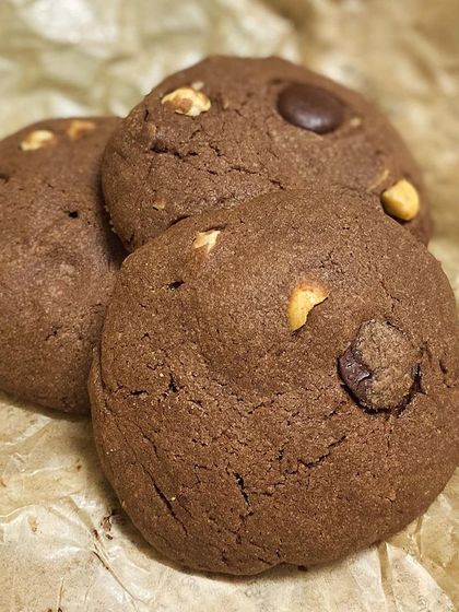 Three of our double chocolate chip cookies, showing their soft, chewy texture and rich cocoa color.