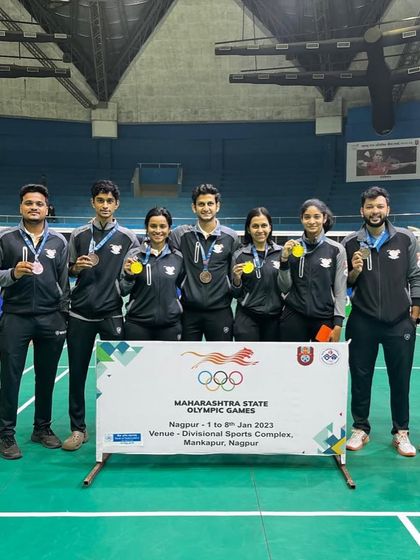 The team proudly displaying their bronze medals from the Maharashtra Olympic Games. This experience enriches our academy's training environment.