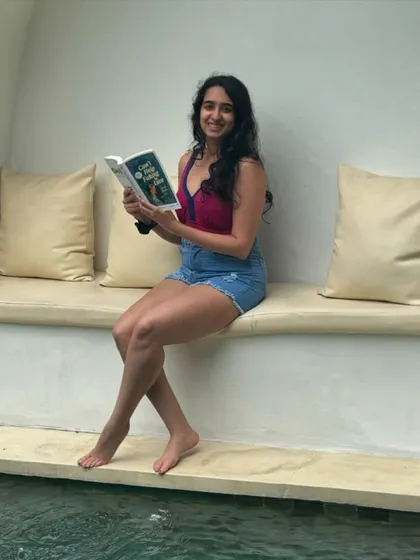 Reading my book, *Can't Help Faking in Love*, by the pool. It's the perfect fun and flirty desi romance for a vacation read.