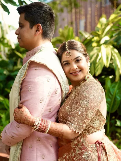 A sweet moment with her partner. Her makeup looks soft and romantic, perfect for these intimate wedding portraits.