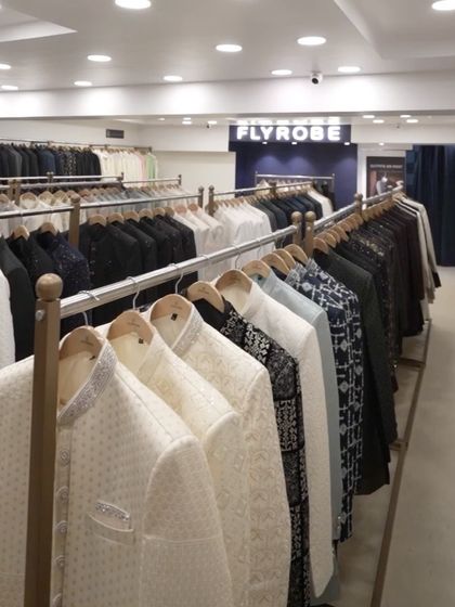 Racks filled with our extensive collection of men's ethnic wear, from classic whites to bold prints and dark hues.