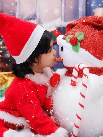 A sweet moment between a little Santa's helper and a snowman. This shot from our Christmas mini-session is full of holiday magic and innocence.