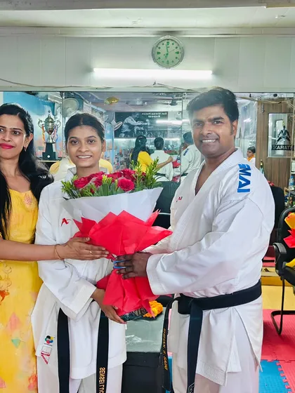A moment of celebration with a student and her family. We believe in creating a supportive community that includes parents in their child's journey.
