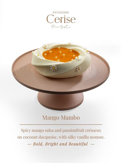 My Mango Mambo entremet, seen here, is bold, bright, and beautiful. It is built with a spicy mango salsa and passionfruit crémeux on a coconut dacquoise base, finished with a silky vanilla mousse.