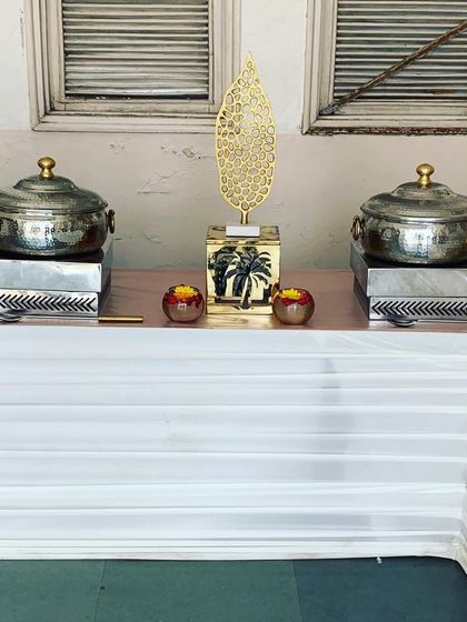 A wider view of our hammered-finish chafing dishes flanked by elegant decor for a birthday celebration.