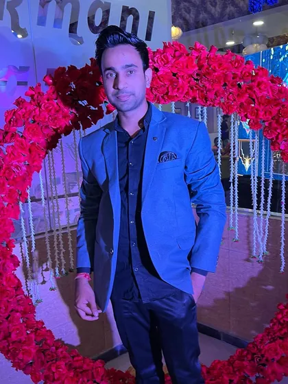 A candid shot against a vibrant, festive backdrop. The life of a performer is always colorful.
