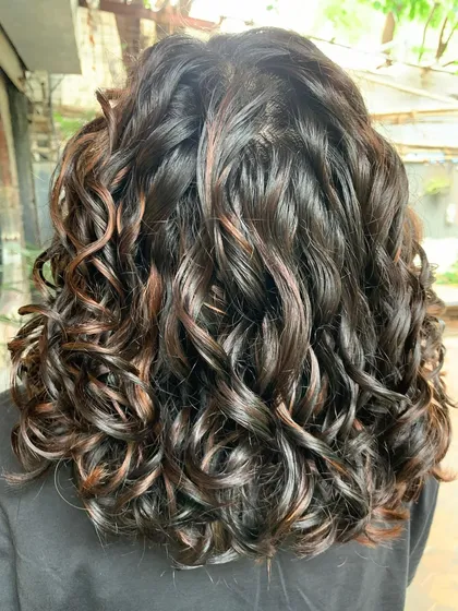 When life gives you curls, flaunt them. This is a beautiful curly bob with deep and light brown non-bleach highlights, perfect for a bride.
