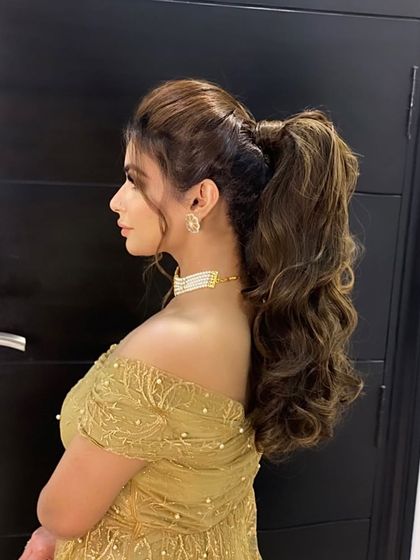 Making heads turn with this messy high ponytail. It's a confident and glamorous look, perfect for a cocktail party or a night out.