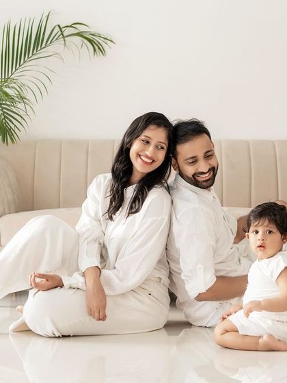 A relaxed family portrait in the studio, with everyone sitting on the floor.