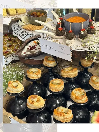 Crispy on the outside, cheesy on the inside. Our Spinach Cheese Poppers are served on individual black pedestals, creating a dramatic and elegant display.
