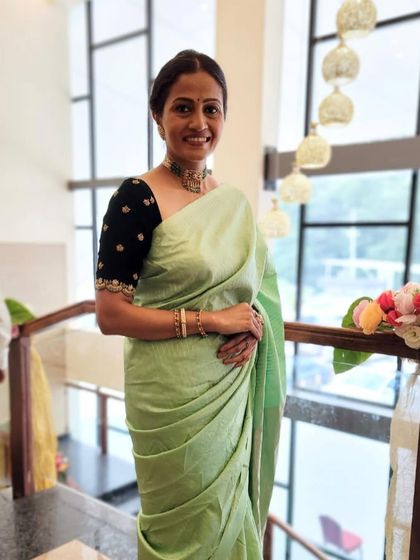Our client Rakshitha looking graceful in a bespoke hand-embroidered velvet saree blouse, perfectly contrasting with her pastel green saree.