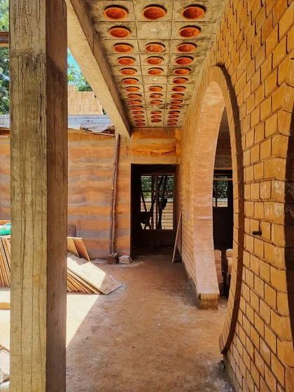 The corridor at 'FM-177', showing the combination of rammed earth walls, brick arches, and a filler slab ceiling.