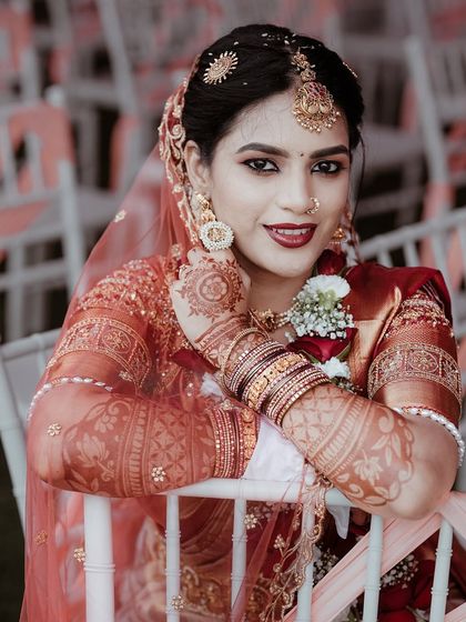 A close up of the bride, showcasing her intricate henna, jewelry, and flawless makeup. This portrait is all about celebrating the beauty of bridal details.