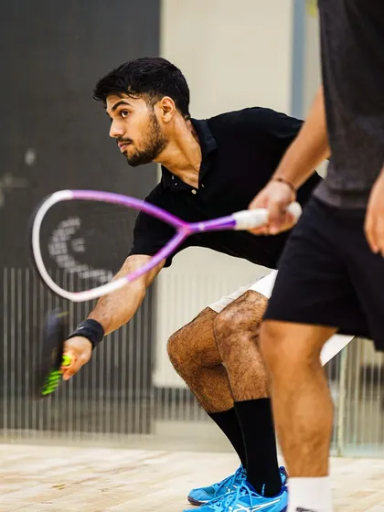 A moment from a doubles practice, showing the close quarters and quick reflexes required. This shot captures the intensity and communication between partners on the court.