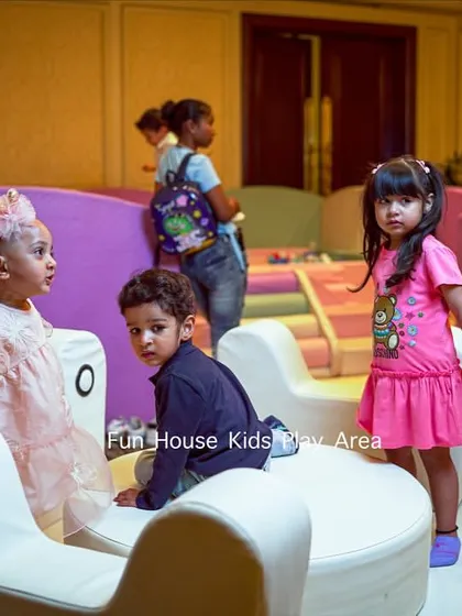Children interacting on the white soft merry-go-round, a centerpiece of our pastel play area setup for a 5th birthday party.