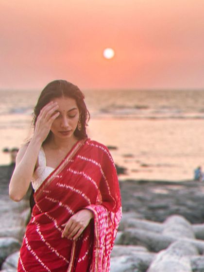 A quiet moment by the sea during sunset. Beach locations offer beautiful natural light and a relaxed atmosphere for lifestyle, wellness, and resort wear campaigns.