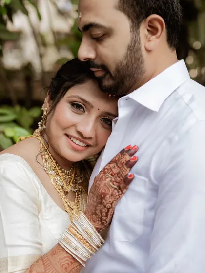 The bride rests her head on her groom's chest, a gesture of trust and comfort. This portrait captures the deep emotional bond and the feeling of finding home in each other.