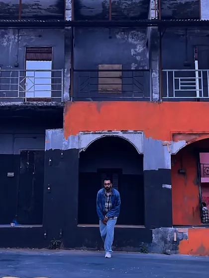 An urban exploration shot against a gritty, colorful backdrop. This is the kind of environment where my streetwear style feels most at home.