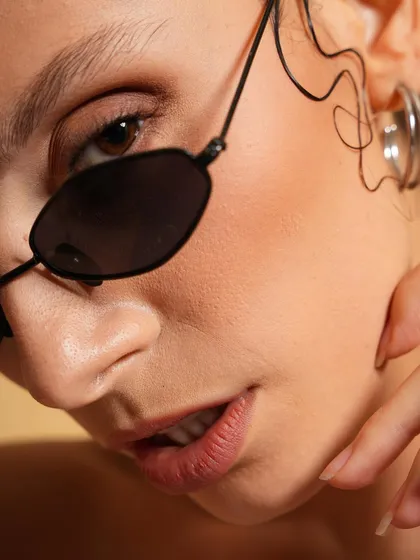 A great beauty headshot is all about the details. This close-up focuses on flawless skin, subtle expression, and the clean lines of the accessories, delivering a polished and professional look perfect for beauty campaigns or model portfolios.