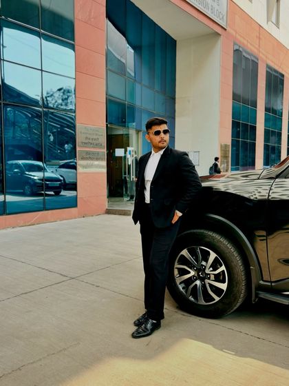 Pictured with my car outside a modern court building. Success is a byproduct of relentless hard work and never giving up.