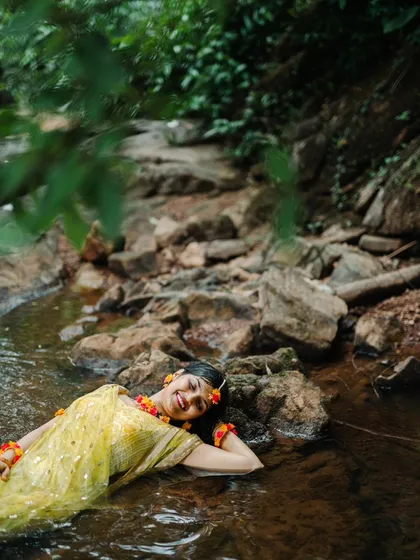 Embracing nature and tradition. This artistic shot from a Haldi ceremony, with the bride to be relaxing in a gentle stream, shows how we can create stunning, unconventional portraits even during traditional events.