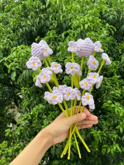 A delicate lilac-themed bouquet with forget-me-nots and heart-shaped flowers.