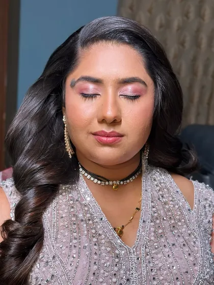 Radiant in sparkle and charm. This reception look is all about shimmer, with bright pink eyeshadow and glowing skin, paired with old Hollywood waves for a touch of classic glamour.