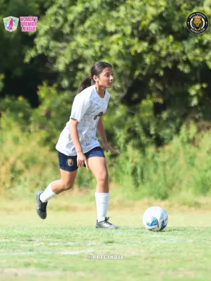 A young player dribbling with confidence, showcasing the emerging talent within our women's football program.