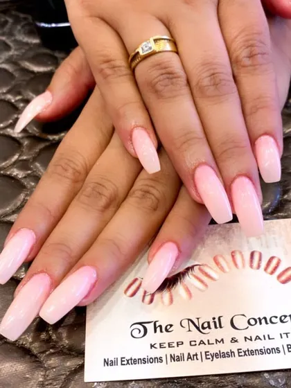 A classic and elegant set of long, coffin-shaped nails in a soft, milky pink color. This is a timeless choice for a clean and polished look.