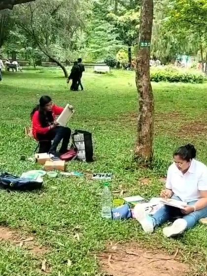 Two artists completely focused on their work during a peaceful Sunday painting session in the park. This is the kind of calm and creative environment I love to foster.