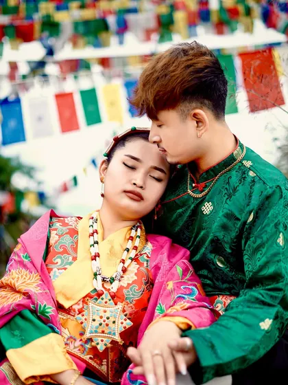 A tender moment captured during a cultural pre-wedding shoot. The groom gently holds the bride, highlighting the beautiful details of her traditional jewelry and attire.