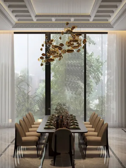 This dining room is a symphony of light, texture, and drama. A cascading chandelier hangs above a sleek marble table, with large windows flooding the space with natural light.