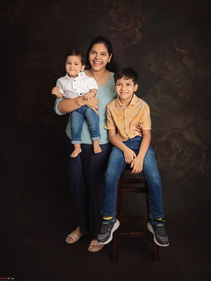 A proud mother with her two handsome sons. This portrait captures the love and joy of being a boy mom.