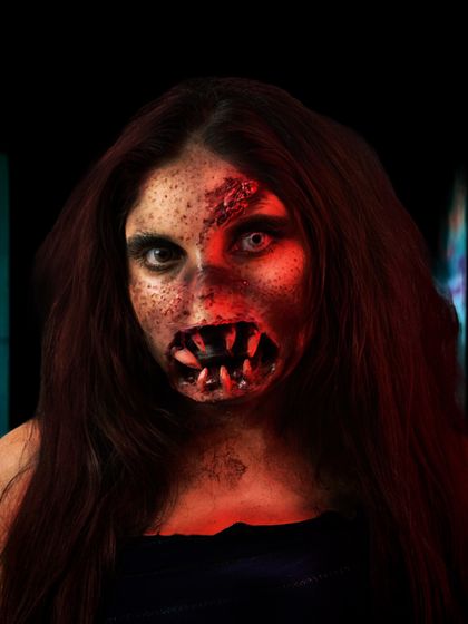 Another shot of the zombie makeup, highlighting the decaying skin texture and unsettling eyes. We teach various texturing techniques for realistic horror effects.