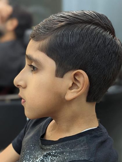 Another angle of this perfect kid's haircut. The side part is precise, and the lines are incredibly clean.