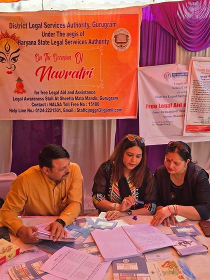 Reviewing documents and providing guidance to a visitor at the legal awareness stall. My colleagues and I volunteer our time to ensure everyone has access to justice, regardless of their ability to pay.