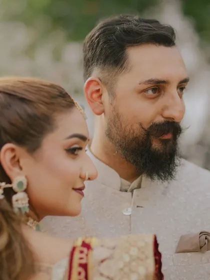 A classic, candid portrait. The bride's gentle gaze and the groom's quiet strength are beautifully captured in this close-up, showcasing the natural comfort they share.