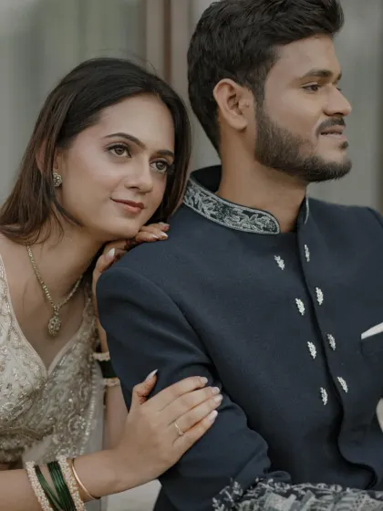 A romantic couple portrait from an engagement. Her soft, natural makeup in a white lehenga complements his classic sherwani.