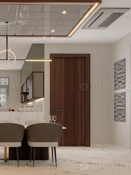 A closer look at the dining space, showing the modern circular light fixture and the textured wooden door, demonstrating my focus on material and detail.