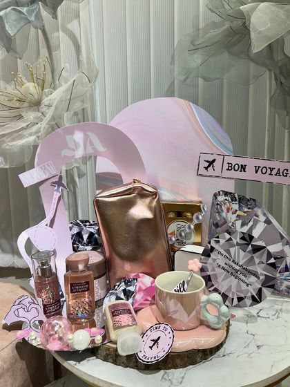 A "Bon Voyage" themed platter, perfect for a sister who loves to travel. It's filled with travel-sized essentials, a cute mug, and other themed goodies.