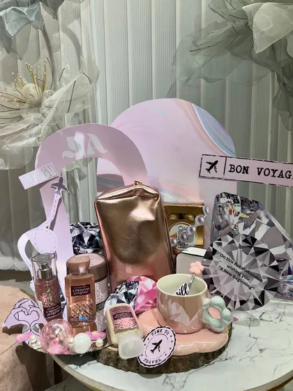 A "Bon Voyage" themed platter, perfect for a sister who loves to travel. It's filled with travel-sized essentials, a cute mug, and other themed goodies.