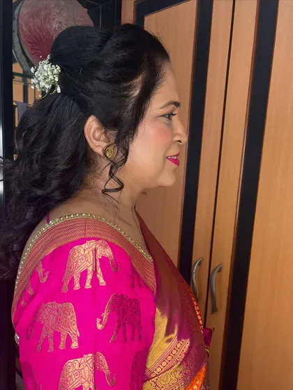 A pretty, curly ponytail hairstyle for my client Dipti. I added a touch of baby's breath for a delicate, feminine feel.