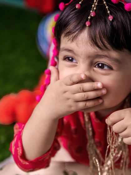 A shy, giggly moment from our Radha-themed shoot. This close-up captures a genuine, unposed emotion that families will cherish for years to come.