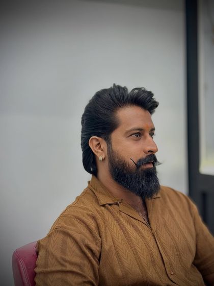 A great shot of this client's strong profile, enhanced by his sharp haircut and well-groomed beard.