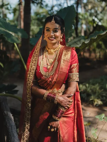 A full-length view of this stunning Tulu bride. The makeup was designed to be timeless and elegant, ensuring she looked radiant from the first ceremony to the last photo.